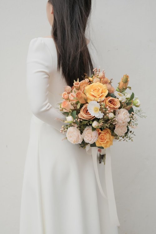 秋のシルクウェディングブーケ、花嫁の手の花束、造花オレンジ