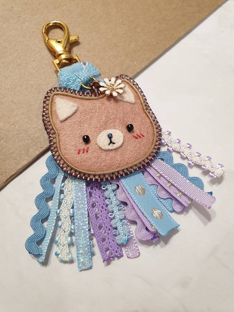 Brown cat with blue/purple tassel keychain