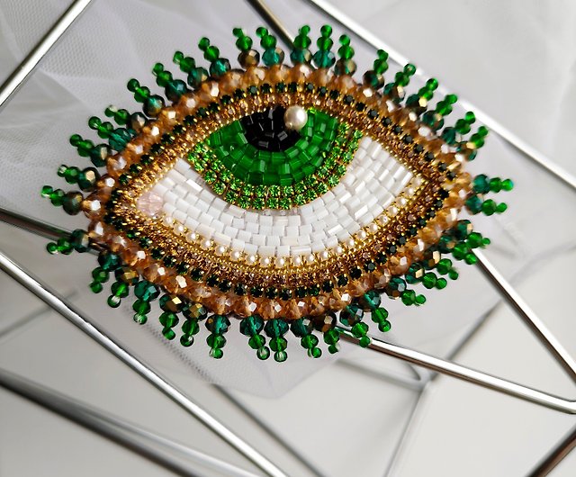 Hand-embroidered eye-shaped green beaded brooch
