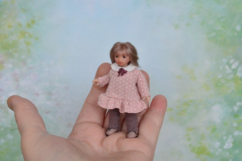 Miniature doll child in 12th scales.