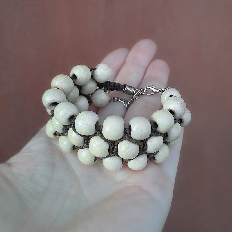 Braided bracelet made of light brown wooden beads and brown cotton cord. - สร้อยข้อมือ - ไม้ สีนำ้ตาล
