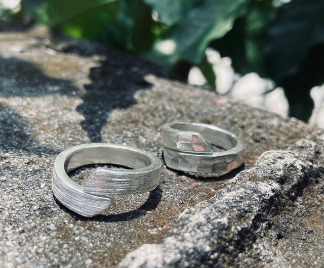 Pair of sterling silver rings with water ripple wood grain one