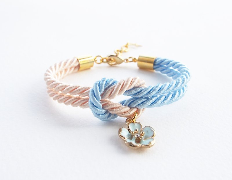 Light blue and ivory cream knot rope bracelet with blue sakura charm - Bracelets - Other Materials Blue